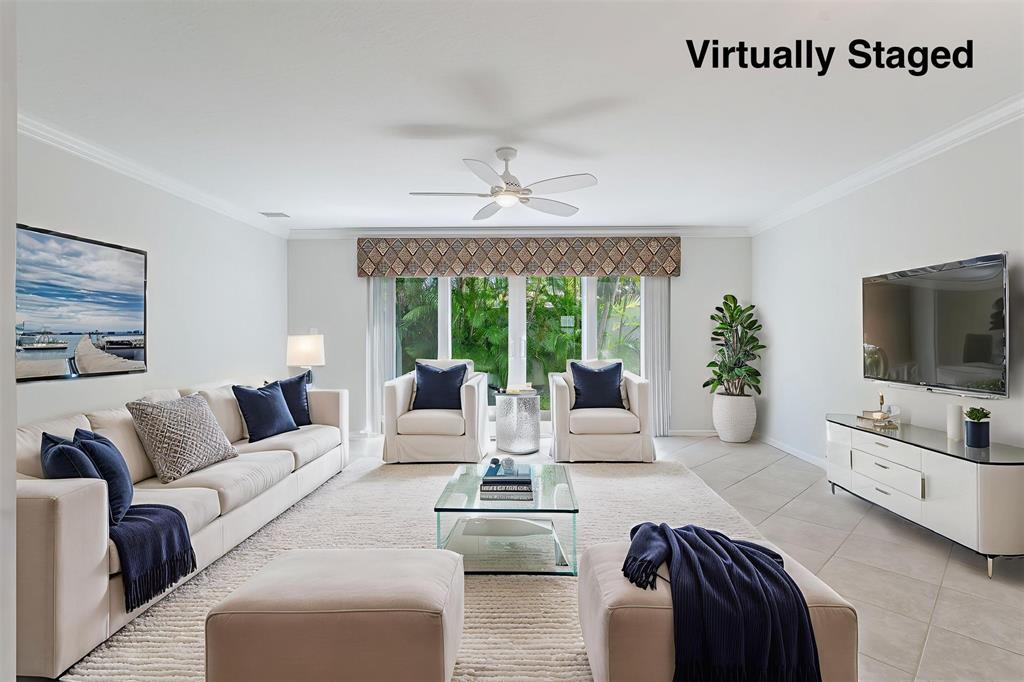 801 Southeast 16th Court, Unit 11 Fort Lauderdale, FL 33316 - Photo 14 of 49 a living room with furniture and a flat screen tv