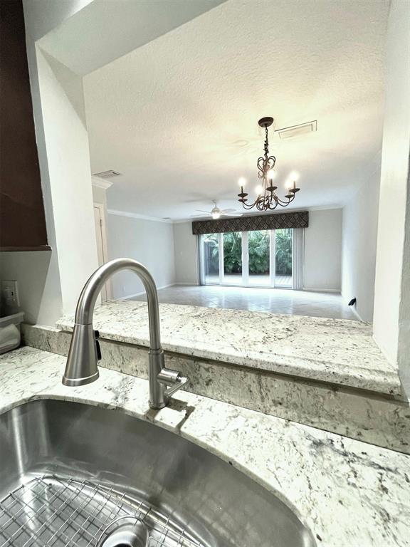 801 Southeast 16th Court, Unit 11 Fort Lauderdale, FL 33316 - Photo 21 of 49 a view of a kitchen with kitchen island a sink stainless steel appliances and cabinets