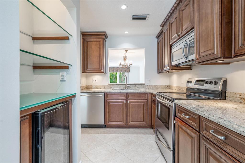 801 Southeast 16th Court, Unit 11 Fort Lauderdale, FL 33316 - Photo 22 of 49 a kitchen with stainless steel appliances granite countertop a sink stove and refrigerator