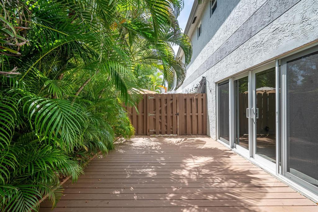 801 Southeast 16th Court, Unit 11 Fort Lauderdale, FL 33316 - Photo 25 of 49 a view of backyard with potted plants and wooden fence