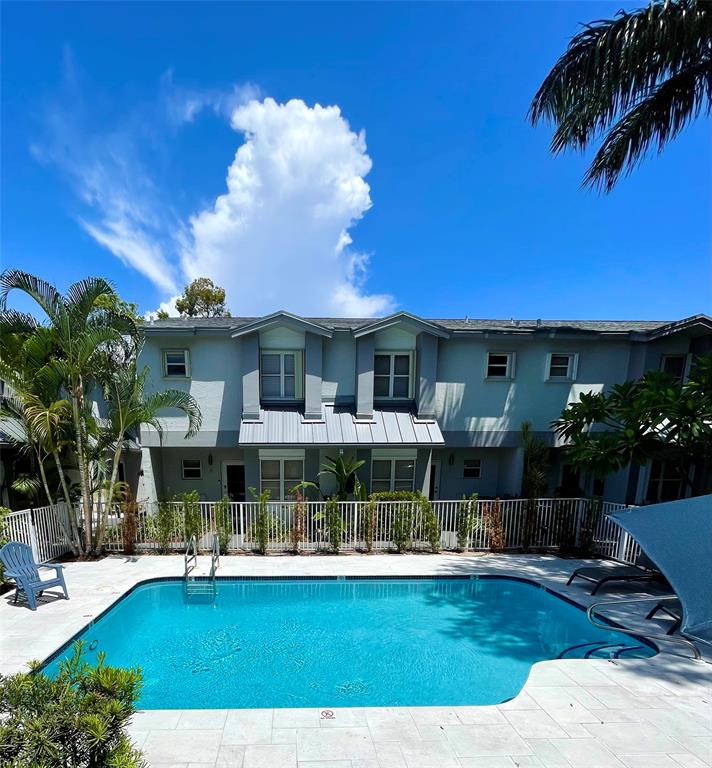 801 Southeast 16th Court, Unit 11 Fort Lauderdale, FL 33316 - Photo 47 of 49 a view of a patio with table and chairs potted plants and large tree