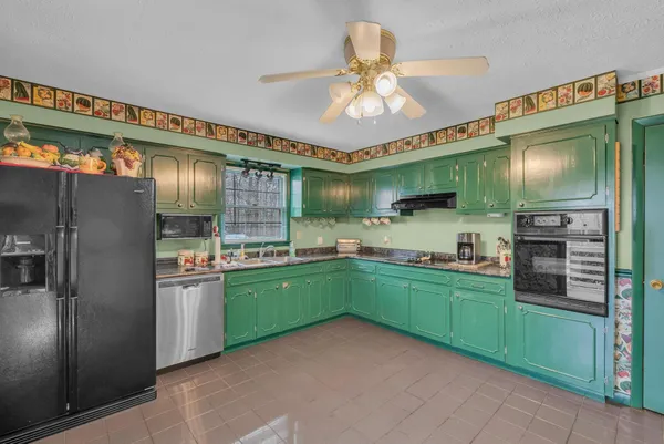 a kitchen with window and refrigerator