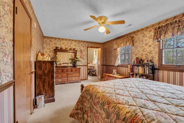 a bedroom with furniture and a chandelier