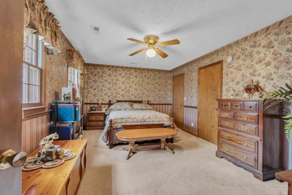 a bed room with a bed and a chair