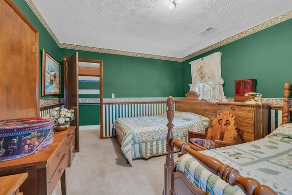 a bedroom with two beds and a large window