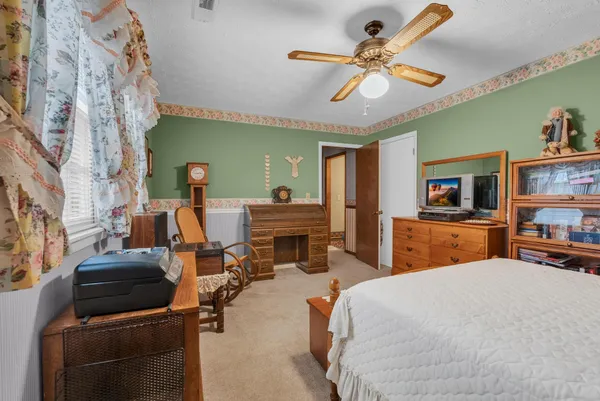 a bedroom with furniture and a flat screen tv