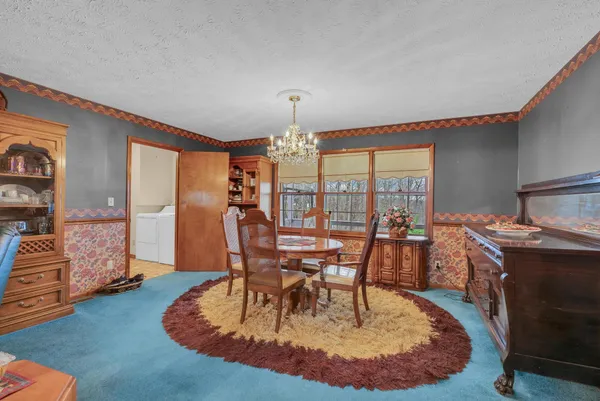a dining room with furniture window and wooden floor