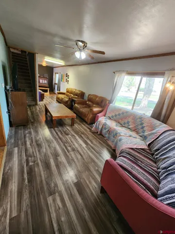 a living room with lots of furniture and wooden floor