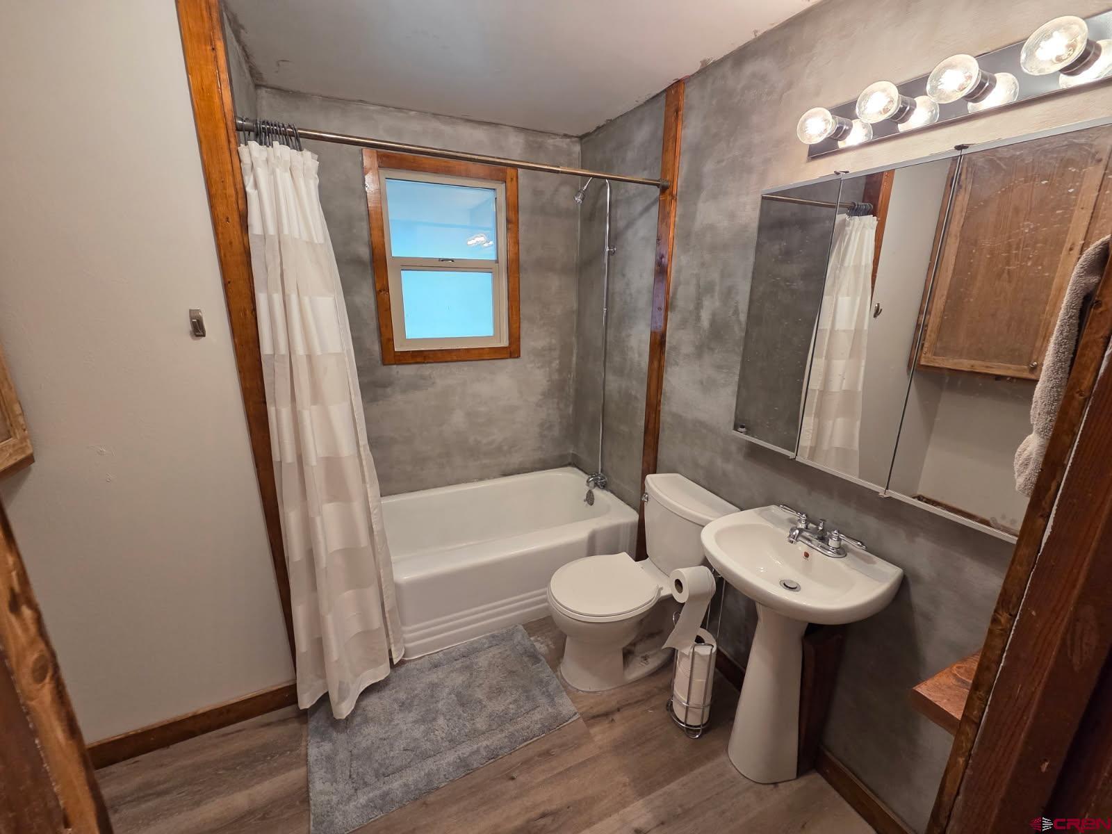610 Ivy Street Nucla, CO 81424 - Photo 14 of 28 a bathroom with a sink a toilet a mirror and shower