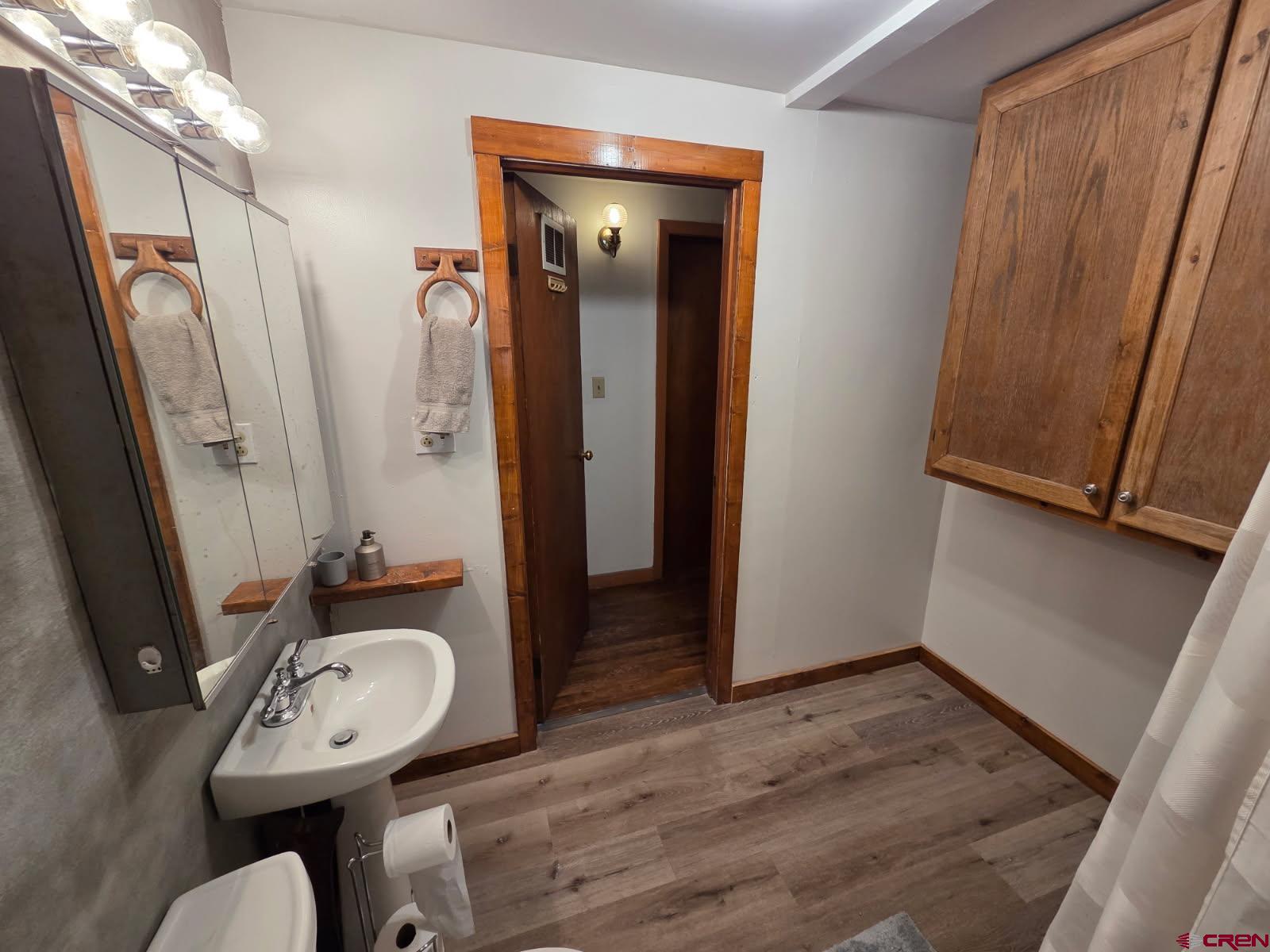 610 Ivy Street Nucla, CO 81424 - Photo 15 of 28 a view of a bathroom with a sink a mirror and a toilet