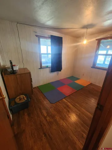 a bedroom with a bed and a mirror