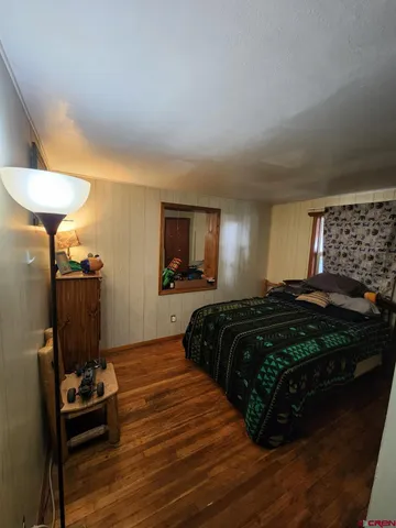 a bedroom with a bed and a chair