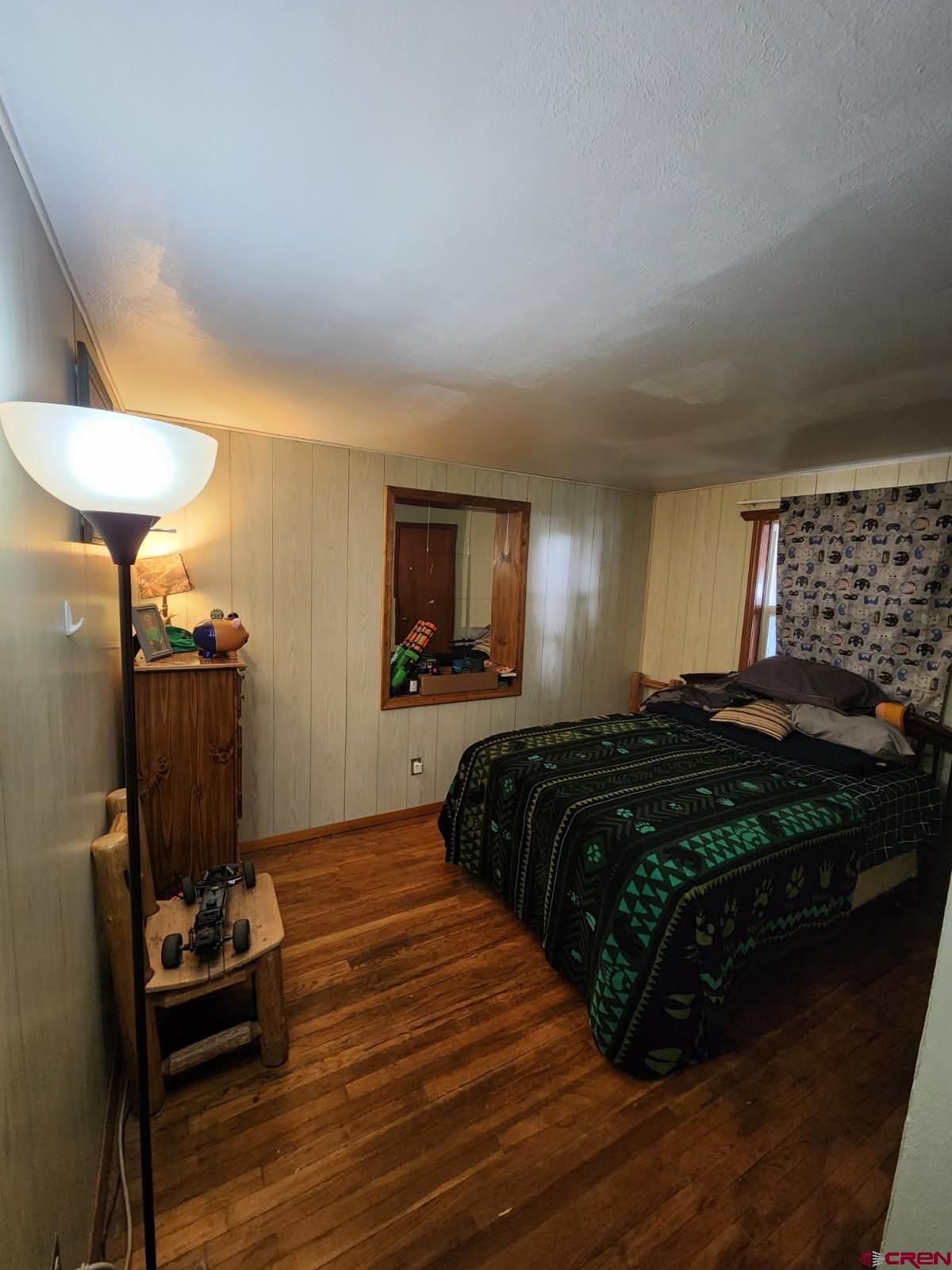 610 Ivy Street Nucla, CO 81424 - Photo 19 of 28 a bedroom with a bed and a chair