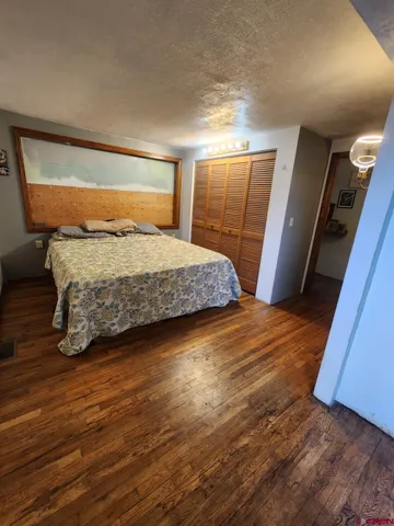 a bedroom with a bed and a mirror