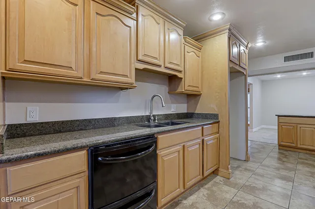 a kitchen with stainless steel appliances granite countertop a sink and cabinets