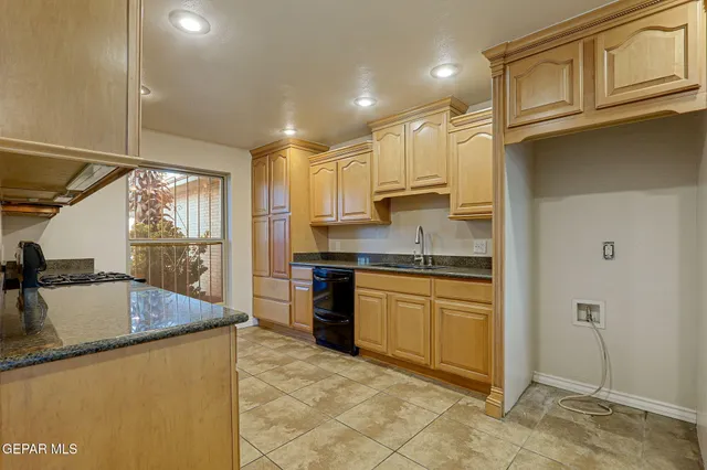 a view of a kitchen with kitchen island a sink a stove and a refrigerator