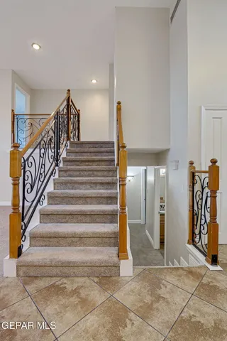 a bathroom with a granite countertop sink a toilet and mirror