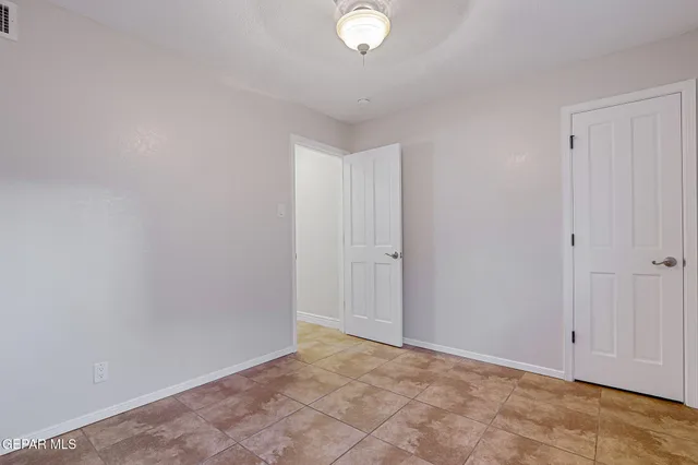 a view of an empty room with a ceiling fan