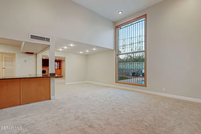 a bedroom with a bed a window and a chandelier