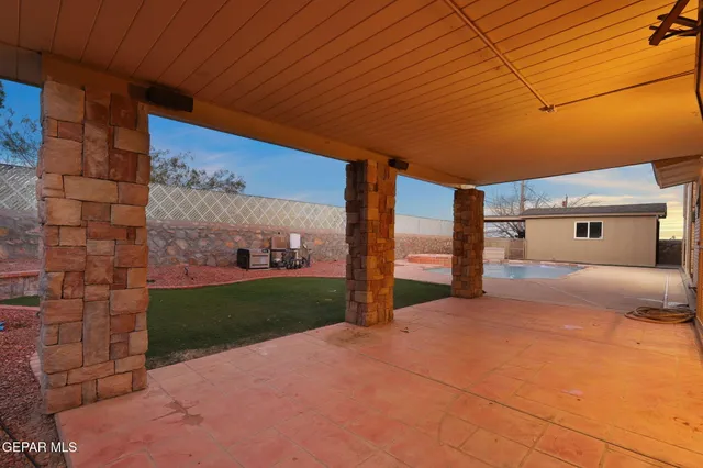 a view of a pool with a chair and table