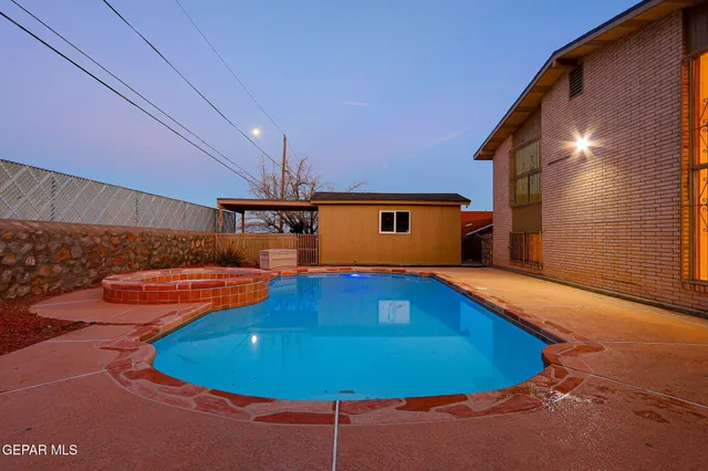 a view of a swimming pool with an outdoor seating and a residential kitchen