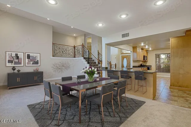 a kitchen with granite countertop a refrigerator a stove and a wooden floors