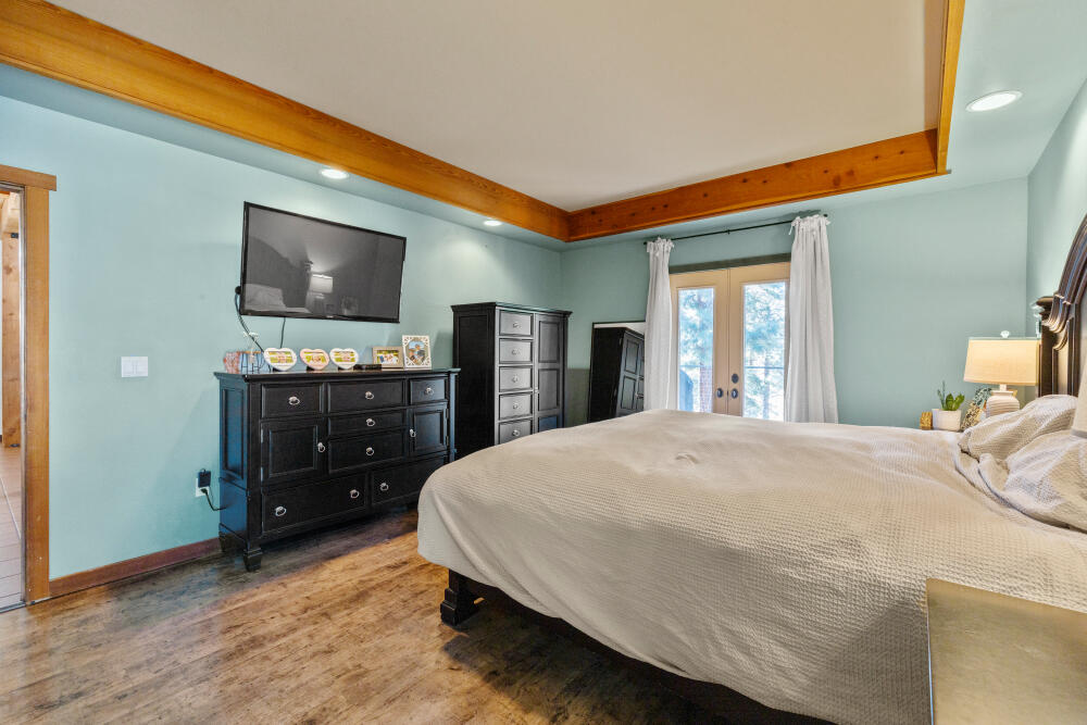 11750 Merganser Road Klamath Falls, OR 97601 - Photo 24 of 66 a bedroom with a bed and a flat screen tv