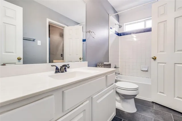 a bathroom with a sink toilet double vanity and shower