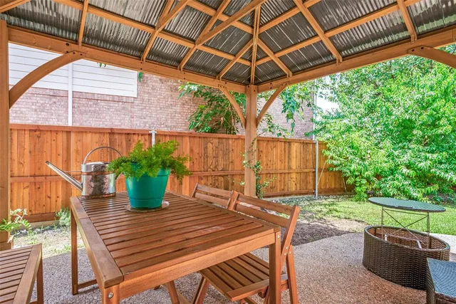 a view of a backyard with sitting area