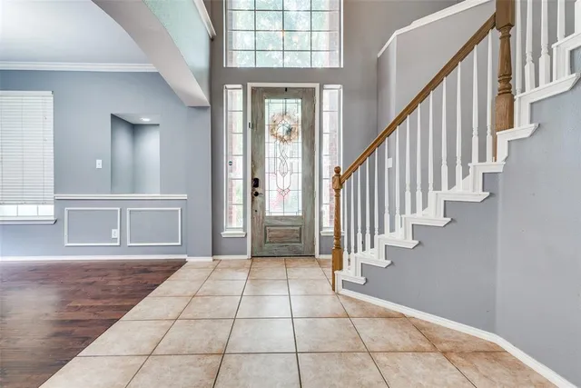 a view of an entryway with wooden floor and stairs
