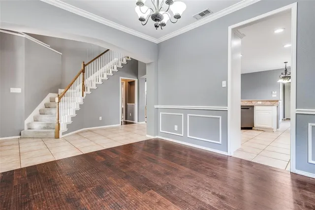a view of an entryway with wooden floor and a living room