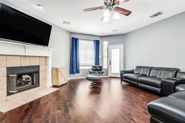 a living room with furniture fireplace and flat screen tv