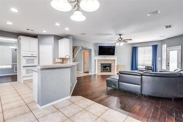 a living room with fireplace furniture and a flat screen tv