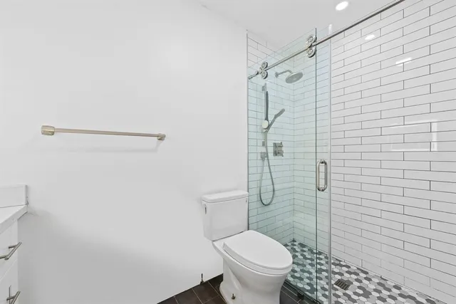 a bathroom with a toilet sink and shower