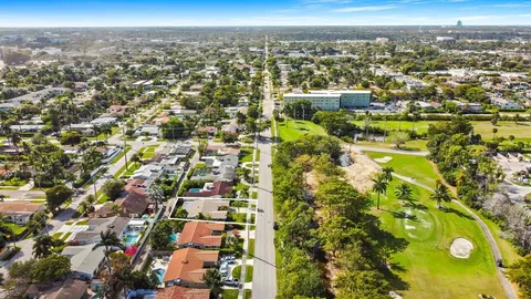 an aerial view of residential houses with city view