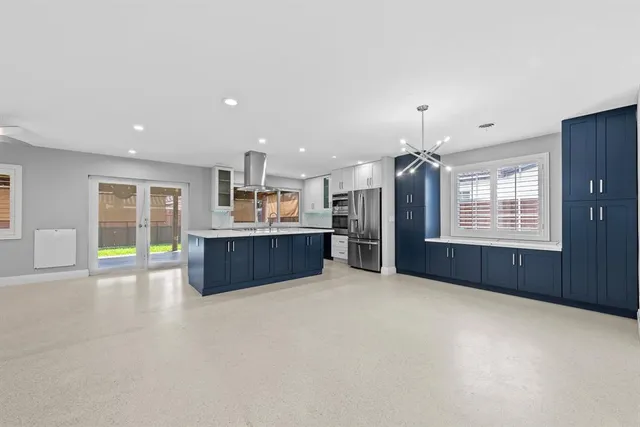 an empty room with a fireplace and windows