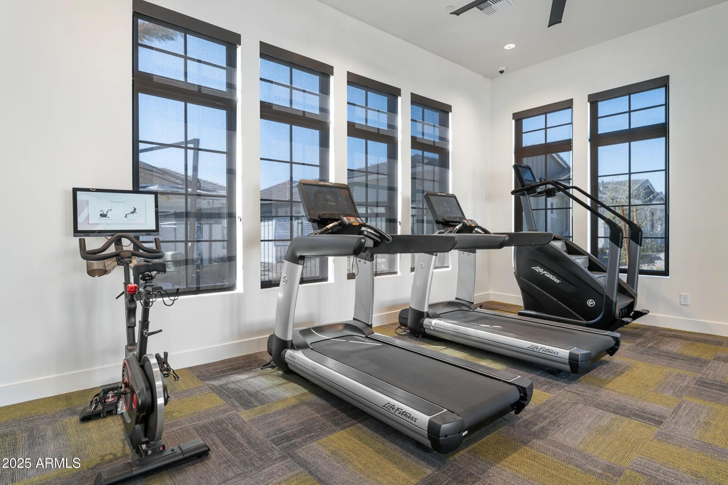 15601 West Cactus Road, Unit 1 El Mirage, AZ 85335 - Photo 16 of 17 a room with gym equipment and a floor to ceiling window