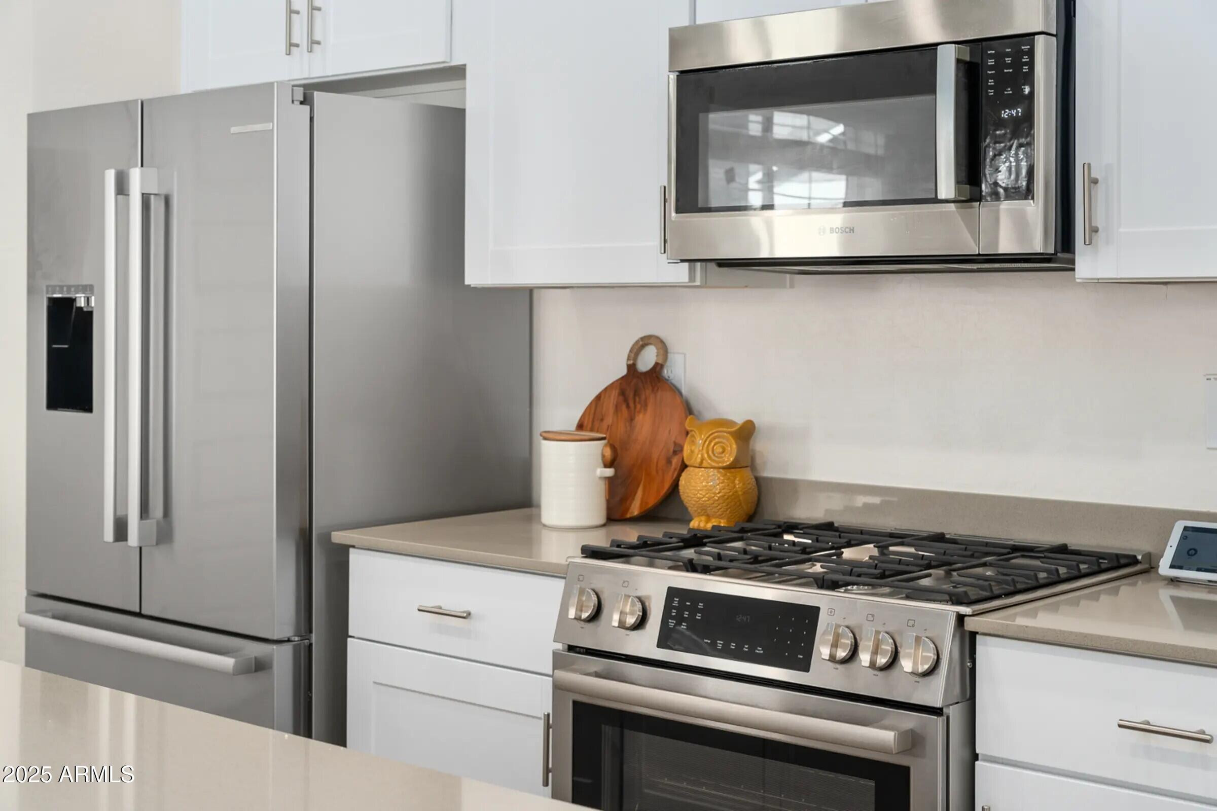 15601 West Cactus Road, Unit 1 El Mirage, AZ 85335 - Photo 2 of 17 a stove top oven sitting inside of a kitchen