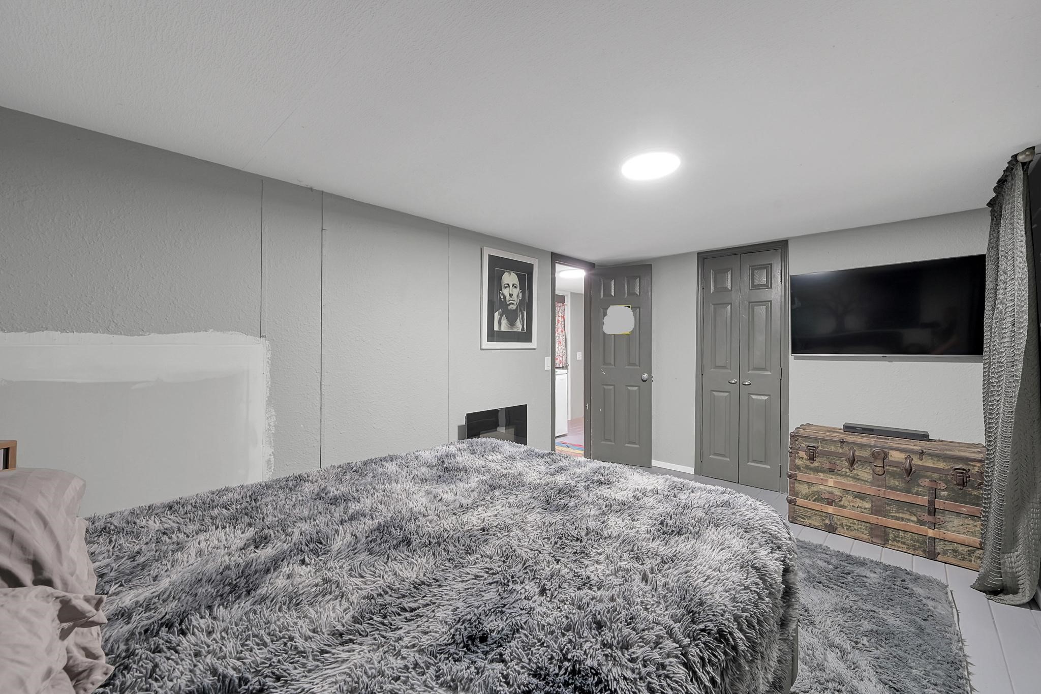 14363 Shepard Hill Road Willis, TX 77318 - Photo 11 of 28 a bedroom with a bed and a flat screen tv