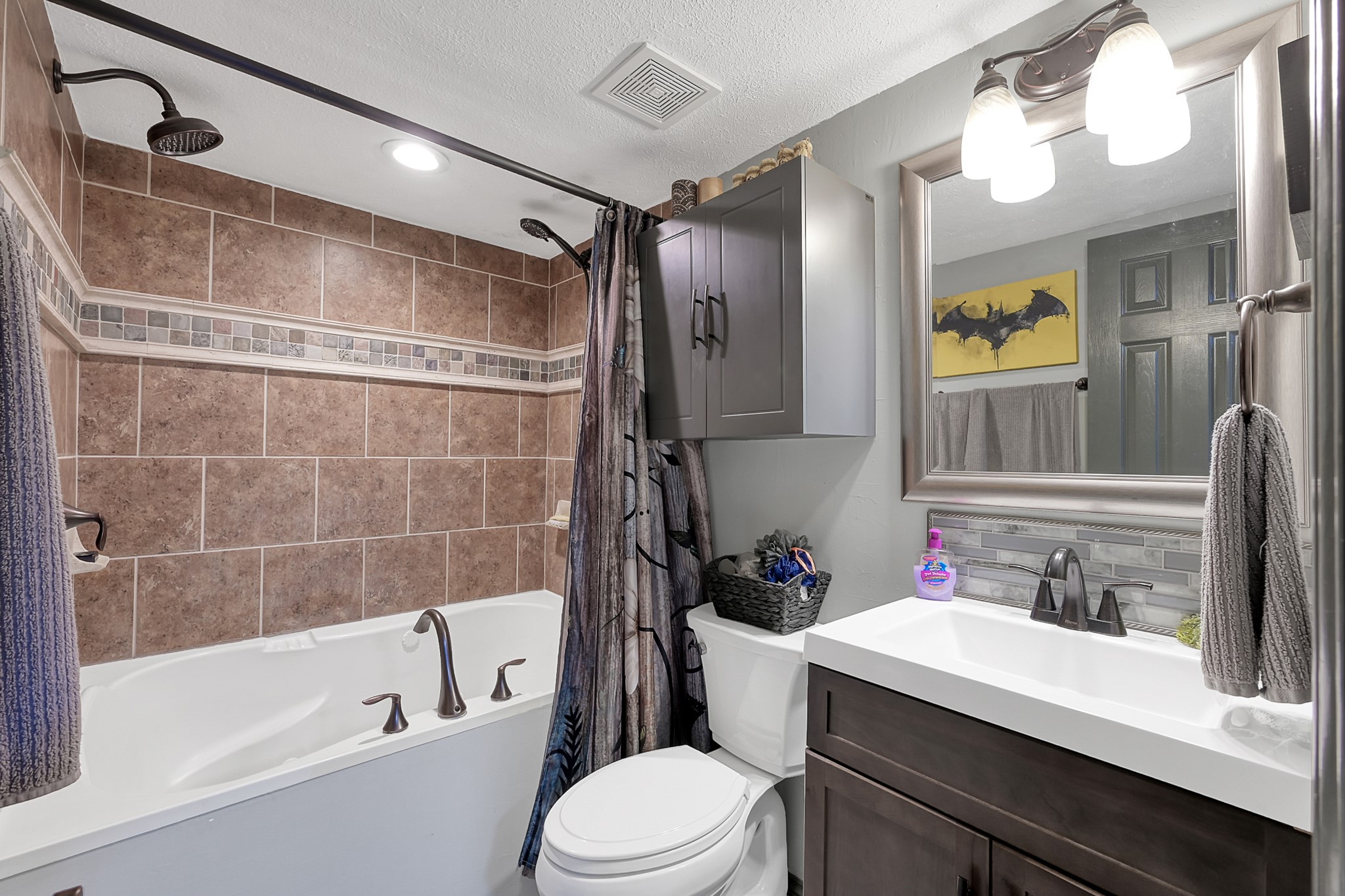 14363 Shepard Hill Road Willis, TX 77318 - Photo 12 of 28 a bathroom with a sink vanity mirror bathtub and toilet