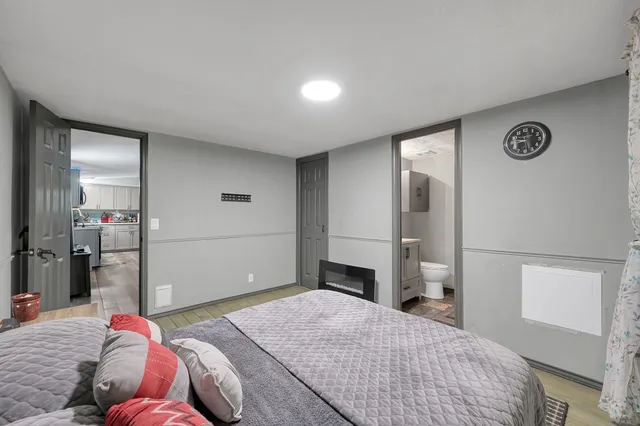 a bedroom with a bed and a mirror