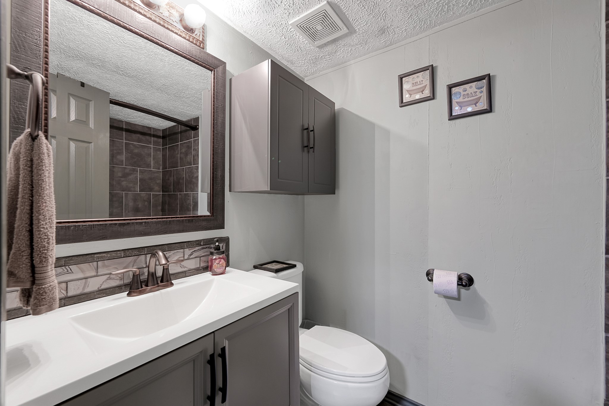 14363 Shepard Hill Road Willis, TX 77318 - Photo 15 of 28 a bathroom with a sink and mirror with toilet