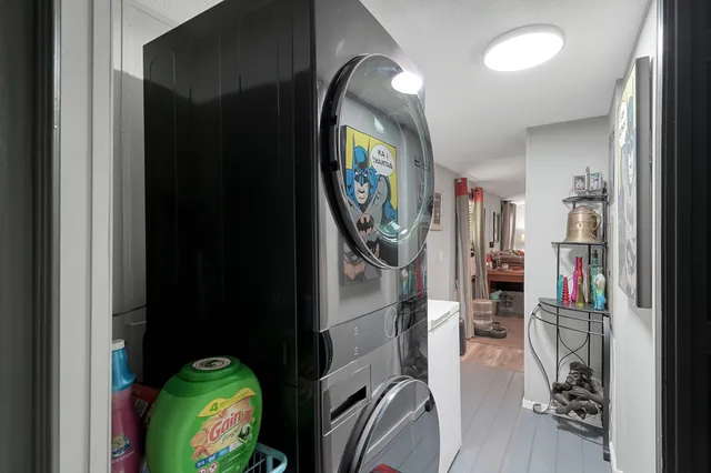 a view of a hallway with wooden floor and entryway