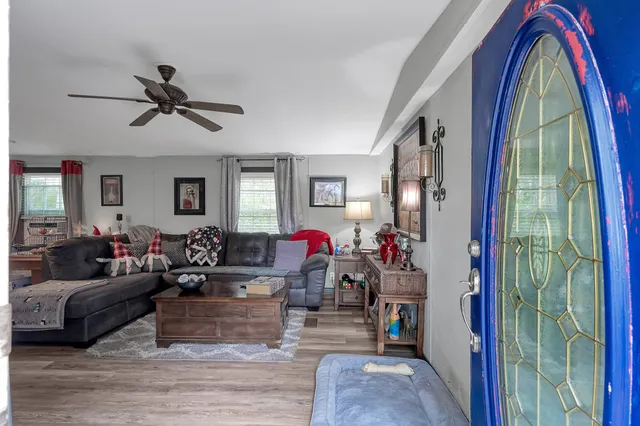 a living room with furniture and a flat screen tv