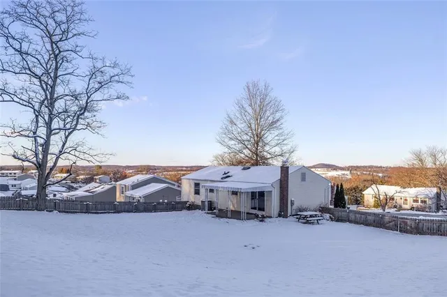 a view of a house with a yard and covered with snow