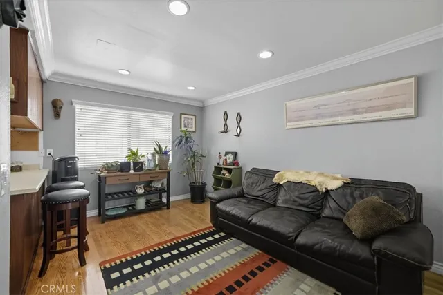 a living room with furniture a dining table and a piano next to a window
