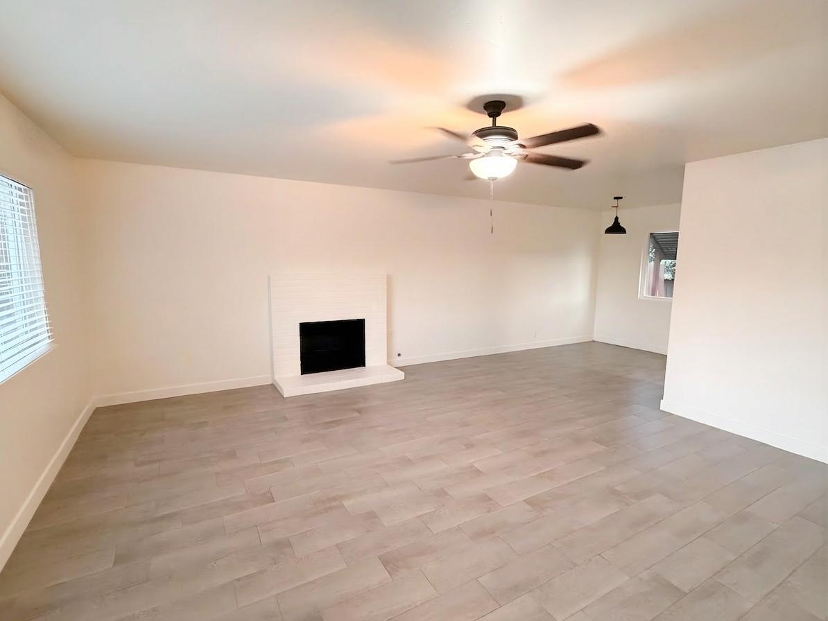 302 Sequoia Drive Exeter, CA 93221 - Photo 4 of 20 an empty room with windows and fan