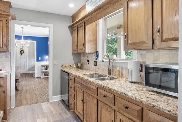 a kitchen with granite countertop a sink and a stove