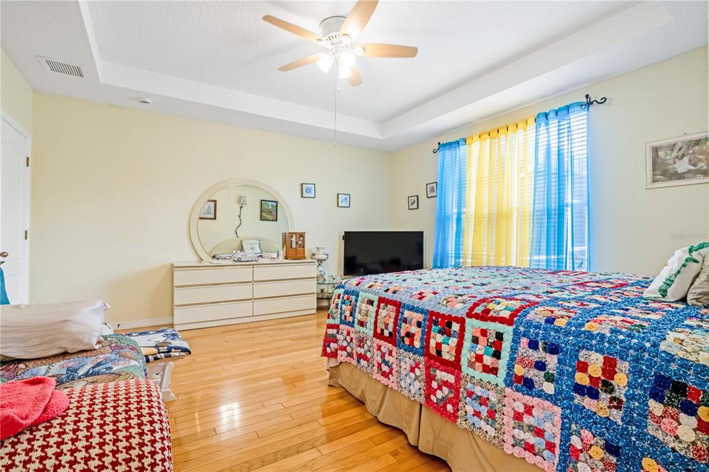 2060 Doyle Road Deltona, FL 32738 - Photo 12 of 43 a bedroom with a bed and wooden floor