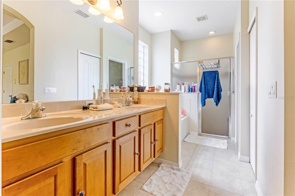 2060 Doyle Road Deltona, FL 32738 - Photo 16 of 43 a bathroom with a double vanity sink mirror and double